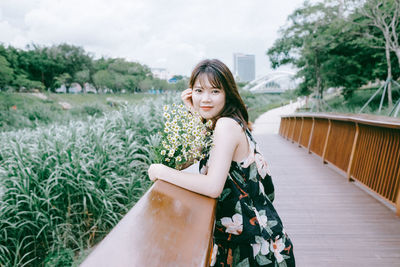 Portrait of beautiful young woman standing outdoors