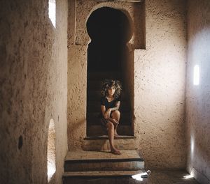 Portrait of woman on steps at doorway