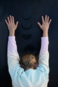 High angle view of woman with arms raised