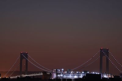 Suspension bridge over river at night