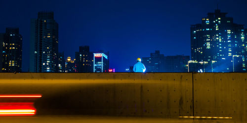 Low angle view of illuminated buildings in city at night