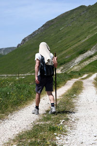 Full length rear view of man standing on mountain