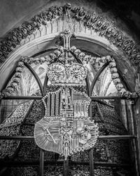 Low angle view of carvings on ceiling of historic building