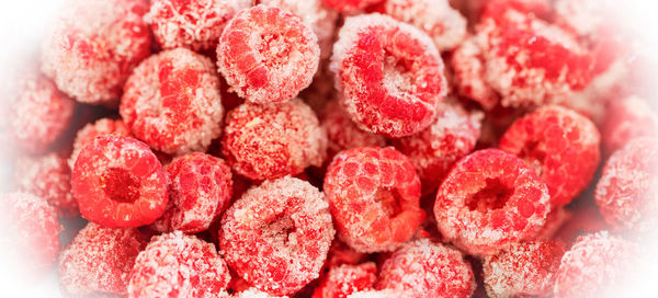 Frozen organic raspberry in white frosty frame. frozen berries retain all vitamins. 