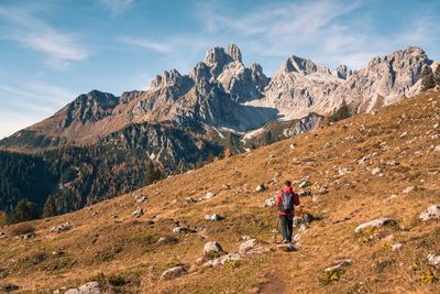 Full length of man walking on mountain against sky