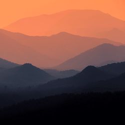 Scenic view of silhouette mountains against sky during sunset