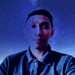 Portrait of man against blue background