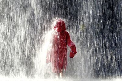 Person in raincoat walking in rain