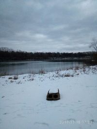 Scenic view of lake against sky during winter