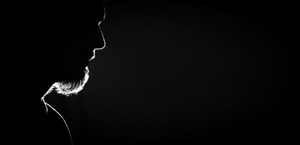 Close-up of illuminated lighting equipment against black background