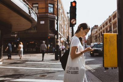 Woman standing on street in city