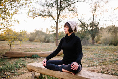 Full length of woman meditating at park