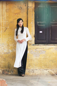 Young vietnamese girl wearing ao dai dress.