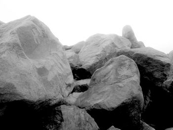 Close-up of rocks against sky during winter