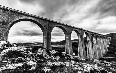 Low angle view of arch bridge against sky