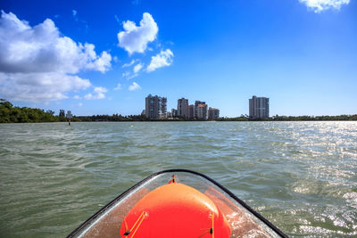 View of city by sea against sky