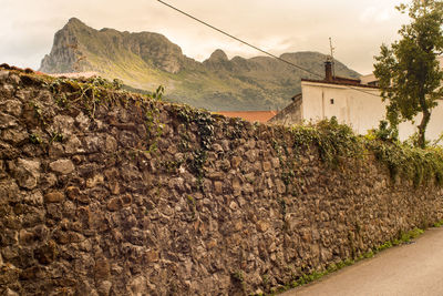 Scenic view of mountains and houses against sky