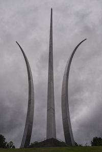 Low angle view of eiffel tower against cloudy sky