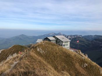 Buildings against mountains and sky