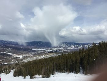 Scenic view of snow covered mountains against sky