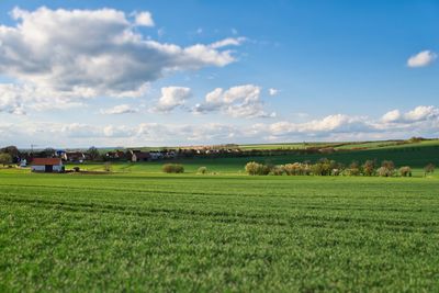 Scenic view of farm against sky