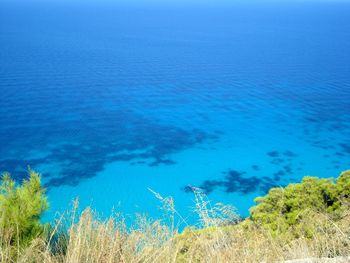 High angle view of sea against blue sky