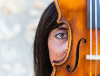 Close-up portrait of woman with violin