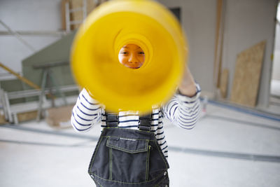 Portrait of boy looking through pipe