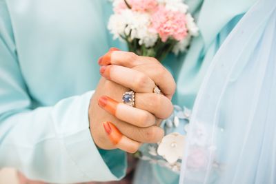 Close-up of hand holding flower bouquet