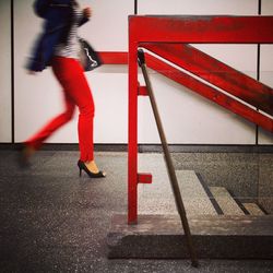 Low section of woman walking towards staircase