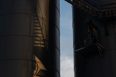 Low angle view of industrial building against sky