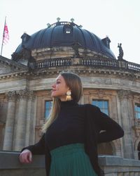 Woman standing in front of building