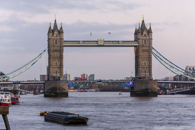 View of bridge over river against cloudy sky