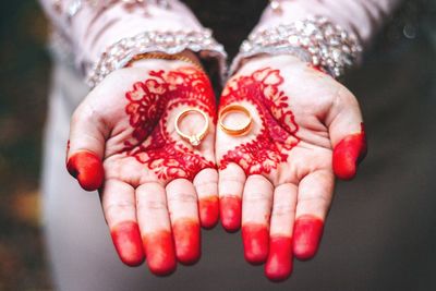 Midsection of bride holding rings