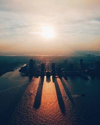 Aerial view of cityscape against sky during sunset