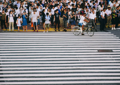 People waiting at zebra crossing 