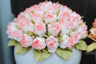 Cropped hand of bride holding roses