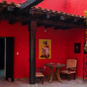 Empty chairs and tables against building