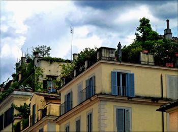 Low angle view of building against cloudy sky