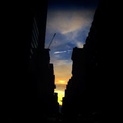 Low angle view of buildings against sky at sunset