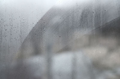 Full frame shot of raindrops on glass window