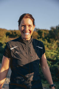 Portrait of happy female coach on sunny day