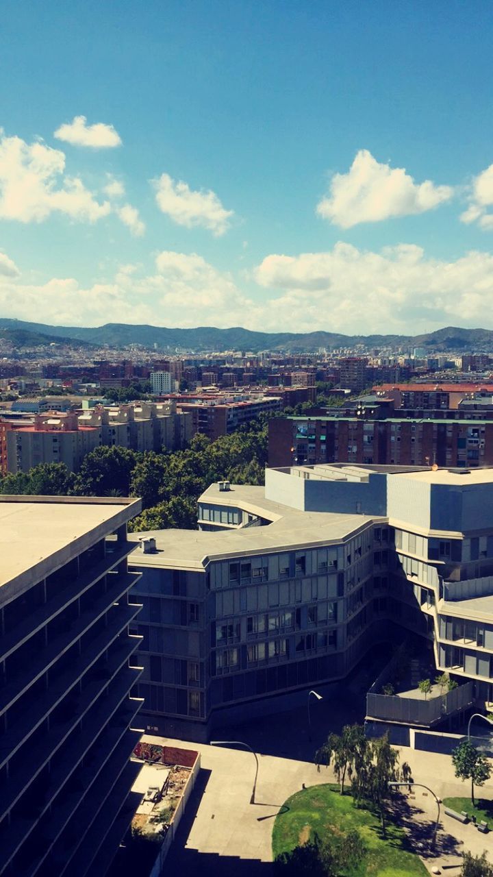 building exterior, architecture, built structure, city, sky, cityscape, high angle view, residential district, residential building, residential structure, crowded, cloud - sky, city life, cloud, street, house, road, day, outdoors, tree