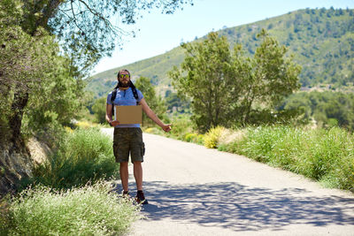 Full length of man standing on road