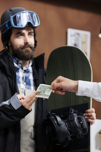 Portrait of young man holding paper currency