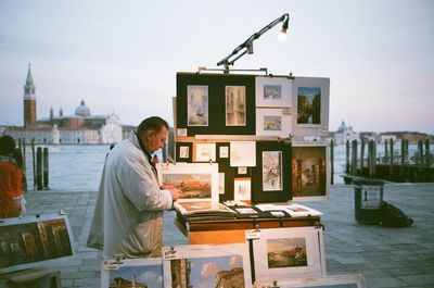 Man standing by built structure against sky