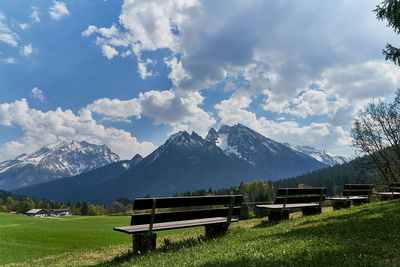 Scenic view of field and mountains against sky