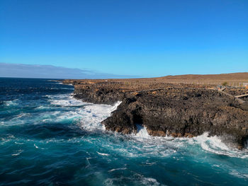Scenic view of sea against clear blue sky