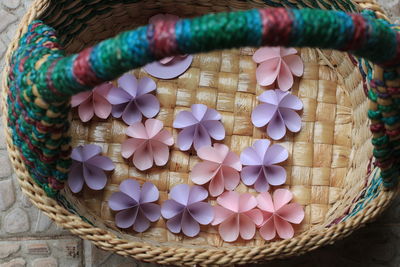 High angle view of paper flowers in basket on footpath