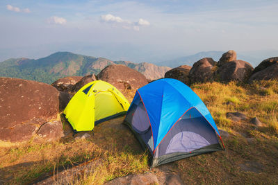 Scenic view of tent on mountain against sky